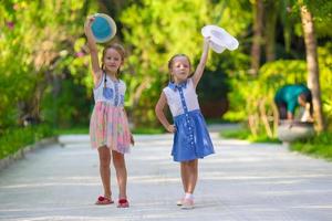 Adorable little girls during summer tropical vacation photo