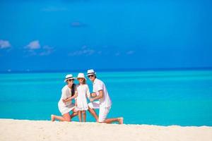 Happy family on white beach photo