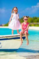 Little adorable girls during tropical beach vacation photo