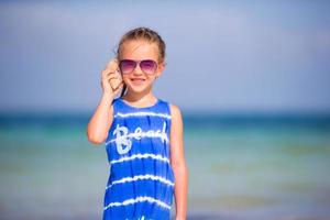 Portrait of adorable little girl with a seashell photo