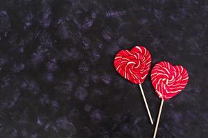 Colorful lollipops on dark background. Top view photo