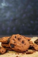 Cookies with chocolate on dark wooden background photo