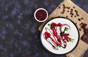 Chocolate fondant with cranberry sauce. Top view. photo
