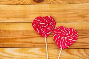 Colorful lollipops on wooden background. Top view photo