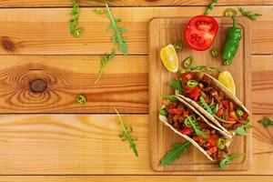 Mexican tacos with beef in tomato sauce photo