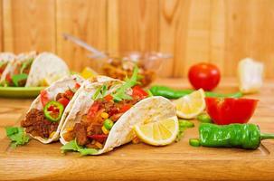 Mexican tacos with beef in tomato sauce photo