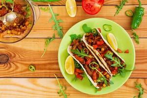 Mexican tacos with beef in tomato sauce photo