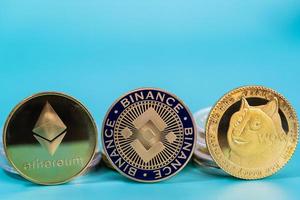 Ethereum ETH, Binance Coin BNB, Dogecoin DOGE group included with Crypto currency coin symbol Virtual blockchain technology future is money blue background close up and Macro concept. photo