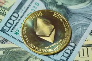 Ethereum ETH included with Cryptocurrency coin on stack 100 hundred new US dollar background it Money American Virtual blockchain technology future is money concept Close up and Macro photography. photo