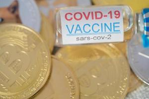 Ampoules Vaccine Covid 19 coronavirus on group of Dogecoin DOGE included with Cryptocurrency coin bitcoin, Ethereum ETH, Binance Coin symbol Virtual blockchain technology future is money concept. photo