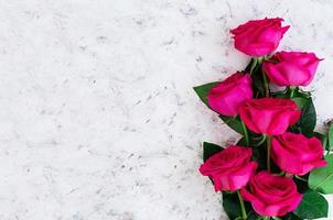 Bouquet of pink roses on dark background. Top view photo