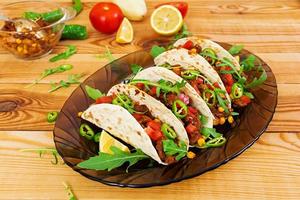 Mexican tacos with beef in tomato sauce photo