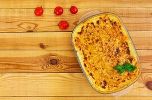 Classic Lasagna with bolognese sauce on wooden background. Flat lay. Top view photo