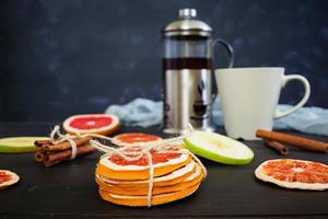 Fruit tea with apple, grapefruit and cinnamon on wooden background photo