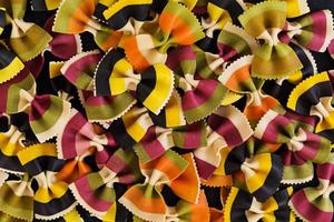 Mixed colorful farfalle pasta. Flat lay. Top view. photo