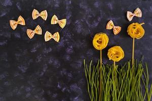 Dry pasta background. Different pasta on dark background. Flat lay. Top view. photo