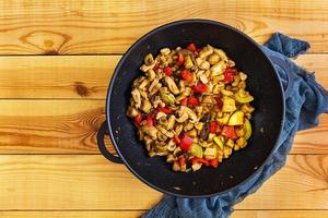 Stir fry chicken, zucchini and pepper in wok photo