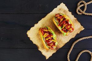 Delicious homemade hot dog on dark background photo