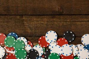 Poker chips on wooden background photo