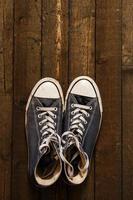 Gumshoes on wooden background photo