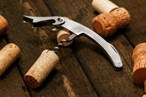 Corkscrew and wine corks photo