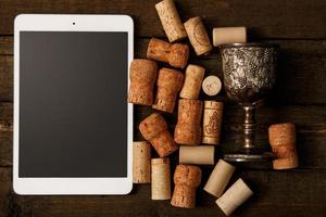 Tablet pc and wine corks photo