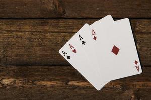Playing cards on wooden background photo