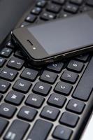 Smartphone and laptop keyboard photo