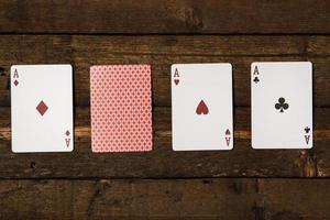 Playing cards on wooden background photo