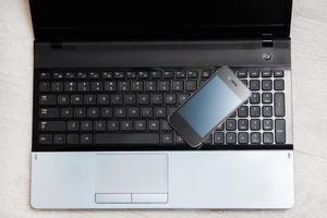 Smartphone and laptop keyboard photo