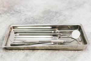 Close-up of a special metal medical set of tools in a dental office. Concepts of the dentist clinic or hospital, teeth and health care. photo