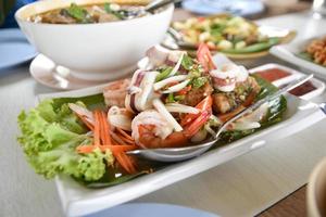 Side view of seafood salad on the table, seafood concept, spicy food, summer vacation photo