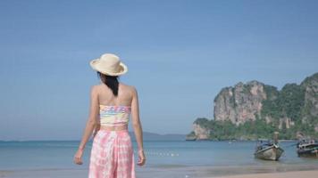 Summer Island beach Blowing Wind In Travelling Adventure Trip, Inspiring Travel Breathe in Fresh Air oxygen, summer time .Woman Hair Flowing On Wind. Asian lady wear straw hat Enjoy Holiday Vacation video