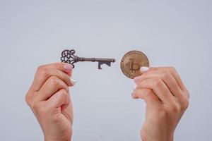 Businessman handing out bitcoins, gold and keys to unlock. cryptocurrencies A new world of online currency development photo