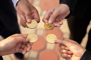 group of businesspeople with bitcoins in hand photo