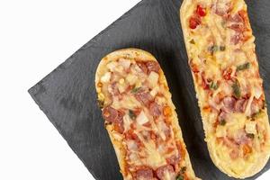 Pizza Baguette on the black stone tray