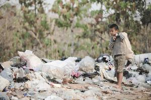 Poor children collect garbage for sale because of poverty, Junk recycle, Child labor, Poverty concept, World Environment Day, photo
