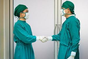 Professional medical doctors performing surgery. Surgeon medical people handshaking, Success and Teamwork concepts photo