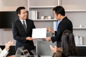 Employee gets a certificate of achievement, Businesspeople with certificate in the office, Businessman giving appreciation certificate to employee for achievement photo