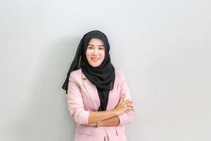 Portrait of Young asian Muslim woman in head scarf smile with arms crossed, Cheerful muslim woman keeps arms folded looking at camera photo