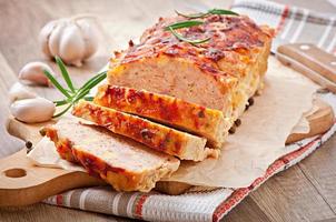 Homemade ground meatloaf with ketchup and rosemary photo