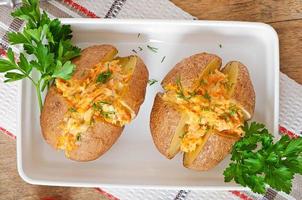 Baked potatoes stuffed with minced chicken and carrots photo