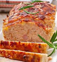 Homemade ground meatloaf with ketchup and rosemary photo