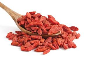 Red dried goji berries in wooden spoon photo