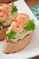 Bruschetta with a paste of green peas and shrimps photo