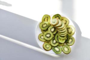 Kiwi fruit sliced on a white plate photo