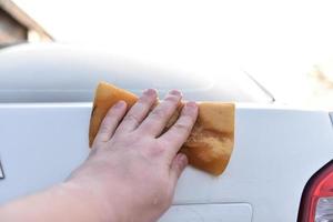 Washing a white car with a sponge by hand photo