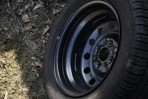 New tire with rubber on the iron disc of the car photo