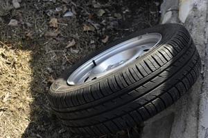 New tire with rubber on the iron disc of the car photo