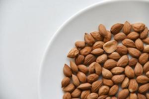 Apricot kernel nuts on a white plate photo